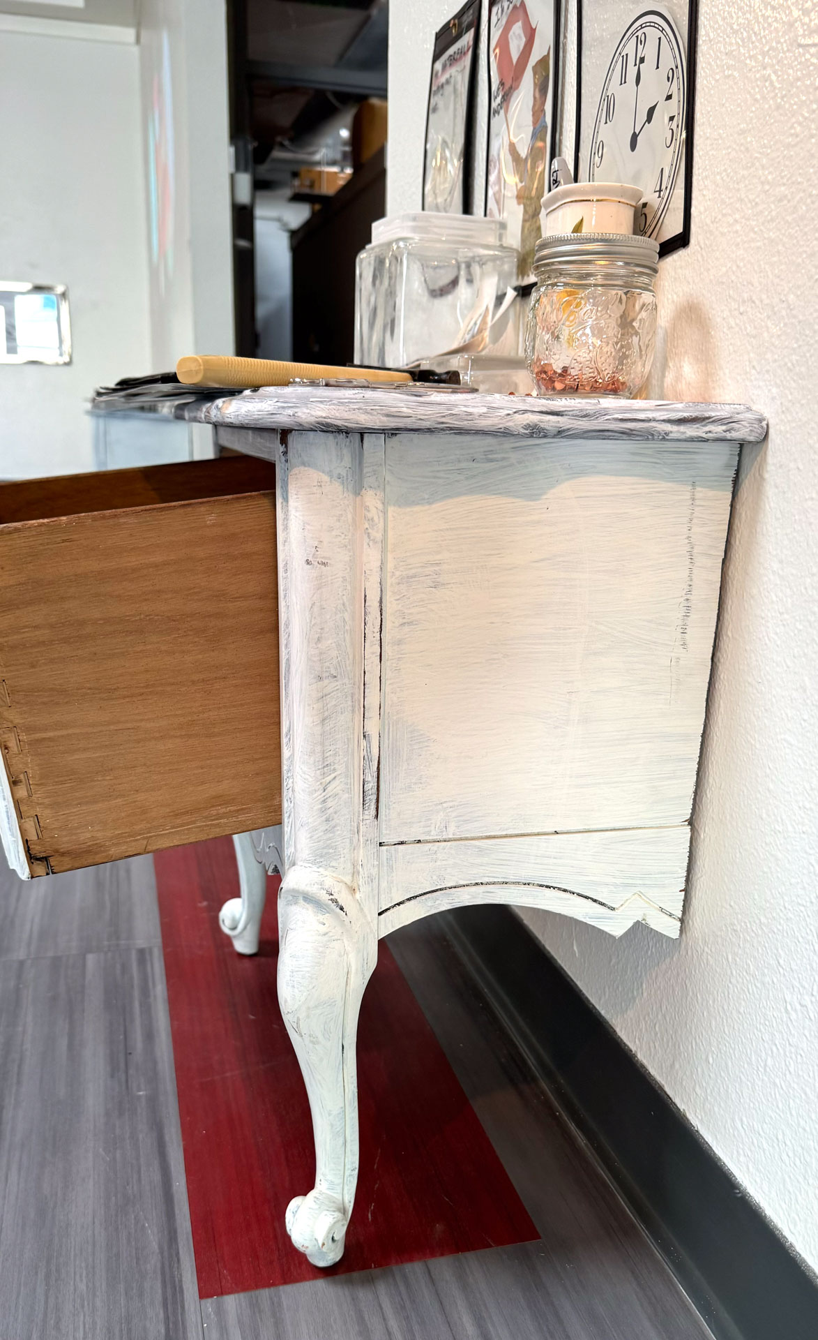 installation with wood table cut in half against wall, job folder, collage materials, audience participation