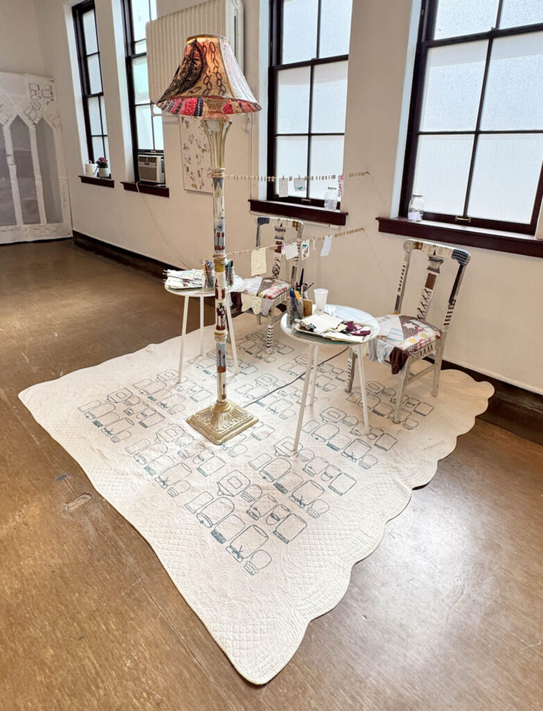 mixed-media installation - collage, monoprint, sewing with lamp, two chairs, two tables, audience participation archive