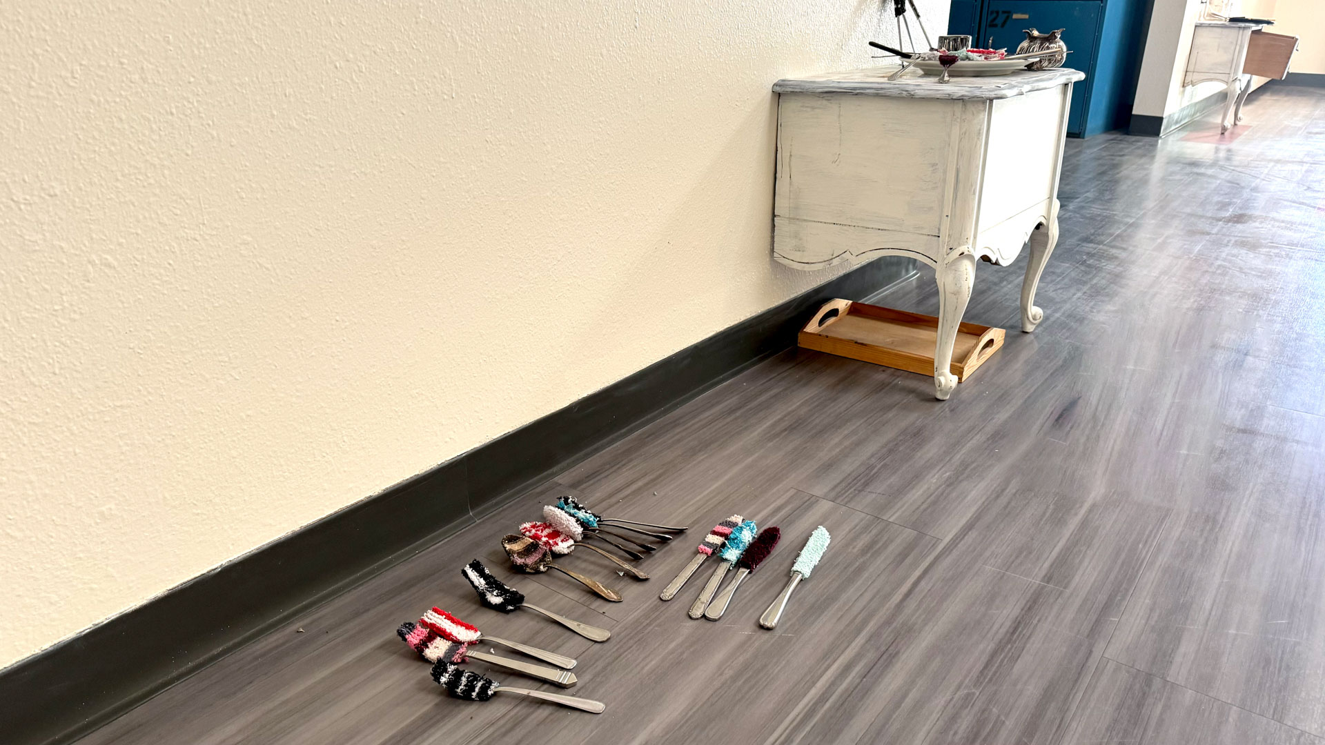 video installation of moving silver utensils with cloth