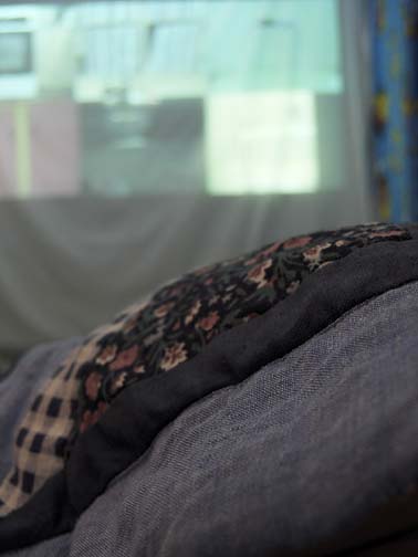 video installation of dometicity scenes in 6 squares inside quilt fort