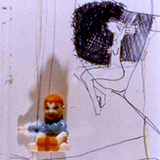 c-print color photo of sketches and toys